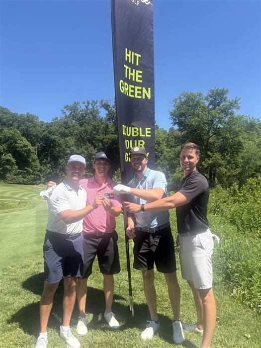 A golfer holding up the gift card he won