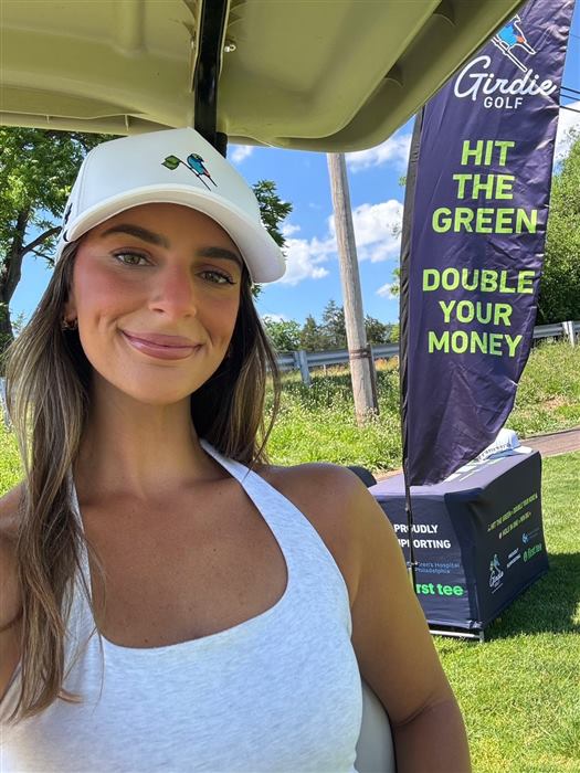 A Girdie Golf staffer in a branded cap at the challenge hole